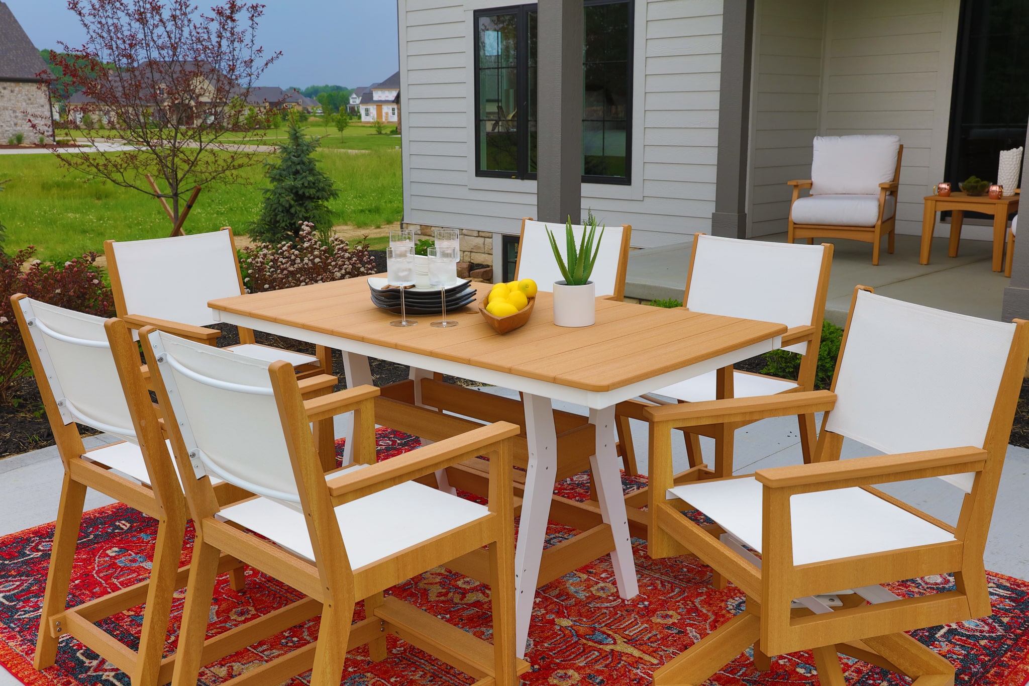 Harbor 33x66 Table in Natural Teak on White with Mayhew Sling and Swivel Counter Chairs 2